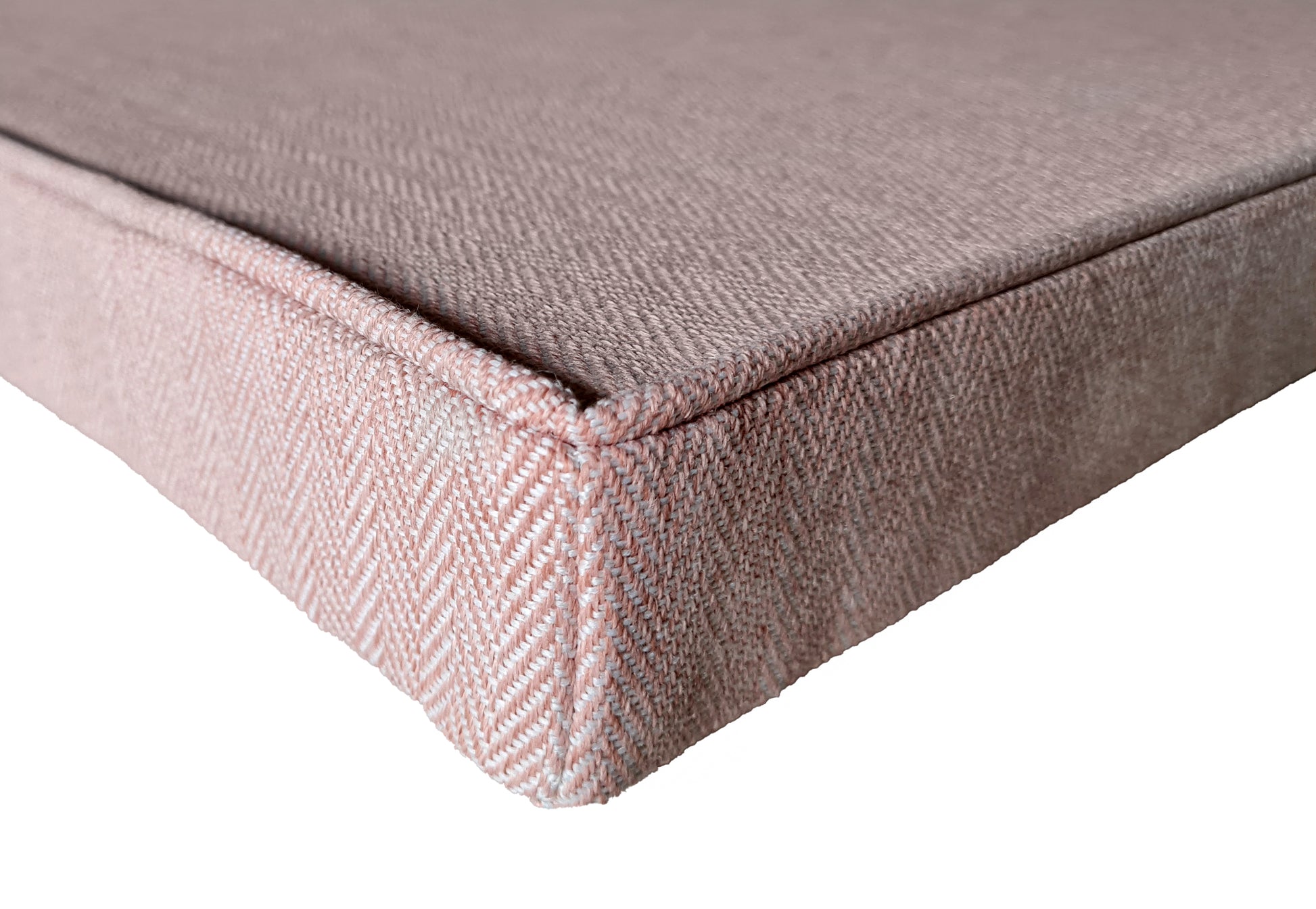A light pink herringbone upholstery fabric bench cushion, wool look fabric bench cushion with a piped upper edge. The fabric is machine washable and can have a stain resistant finish. The box cushion has a zip at the back so the cover can be removed. Perfect for a kitchen banquette seating area or storage seat. The hardwearing pink fabric is perfect for use around kids, children and pets, kitchens and dining spaces. Corner dining seats, in built wooden benches, velcro straps and ties 