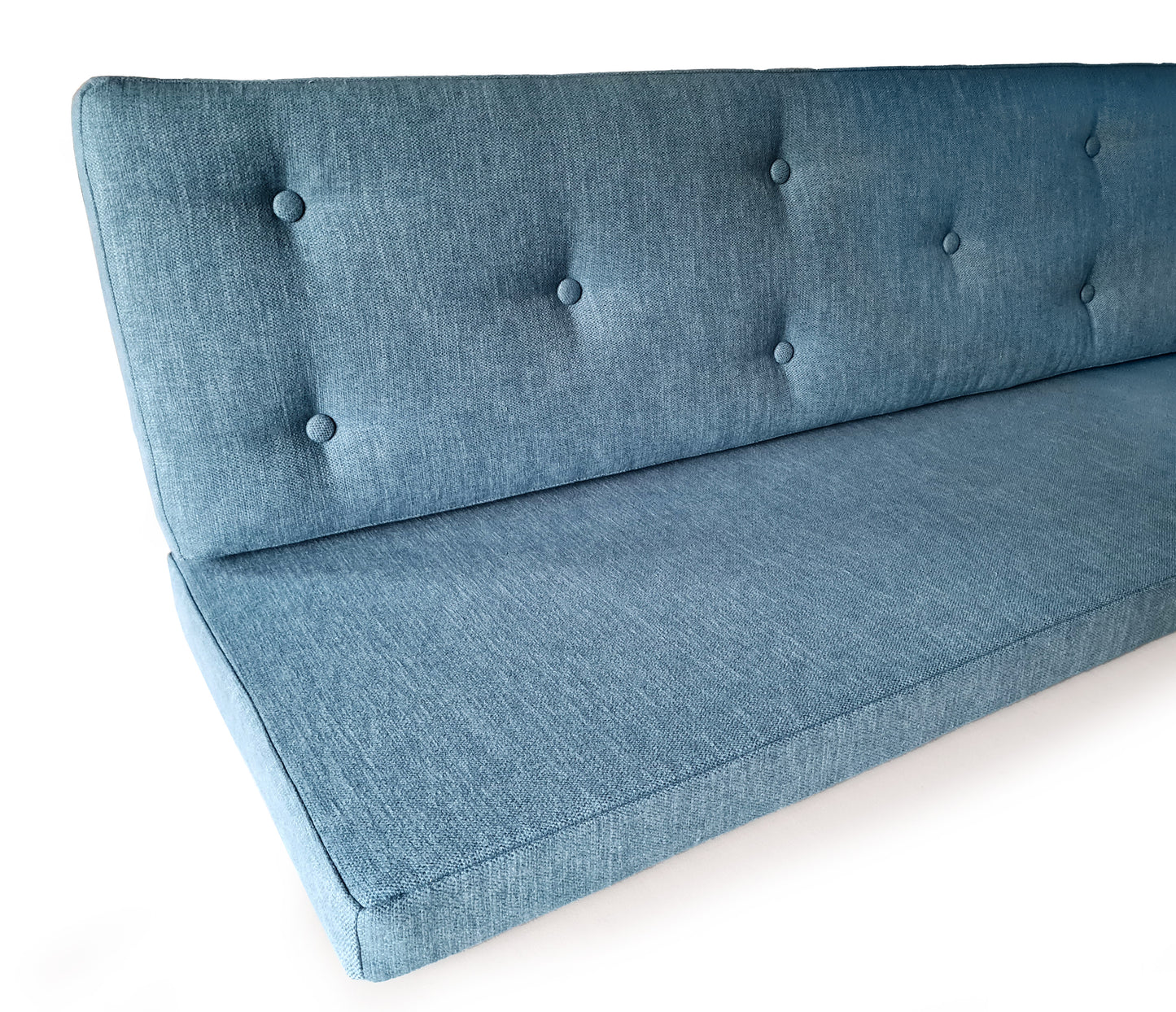 A set of two cushions for a dining seat area. There is a seat cushion which is made with firm upholstery foam which is long lasting and comfortable. The back cushion in the set is made with the same foam, with a dacron layer. The back cushion has been hand tufted with buttons in the same blue fabric. The back and seat cushions both have covers made with a mid blue, woven, linen look fabric which is hard wearing and stain resistant. The seat cushion for the banquette has a zip at the back