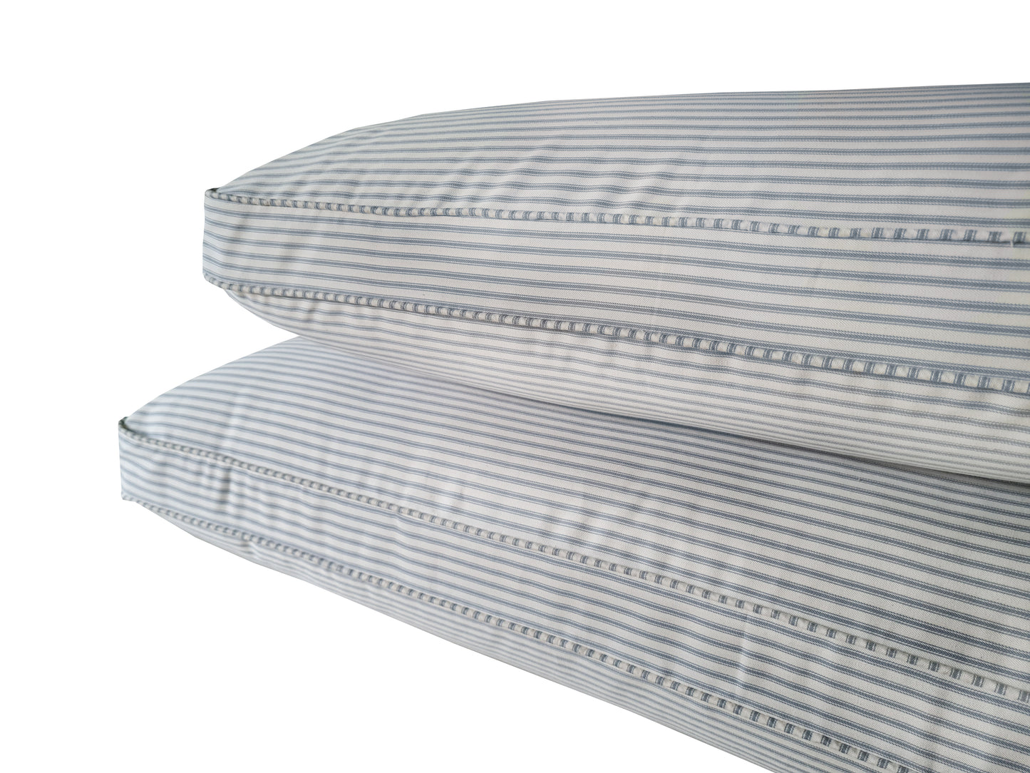 Two thick hollowfibre bench cushions made to measure with Ian Mankin cotton ticking fabric covers in off white and light blue stripes. French country chic cotton fabric bench cushions with thick, plump, comfortable sofa style filling. Recycled plastic bottle fibre filled banquette seating cushions. Thick back cushions for sofa style seating area. Sink in soft feather and foam cushion pads made to measure in yorkshire UK. Piped edge cotton ticking fabric seating cushions for rattan furniture