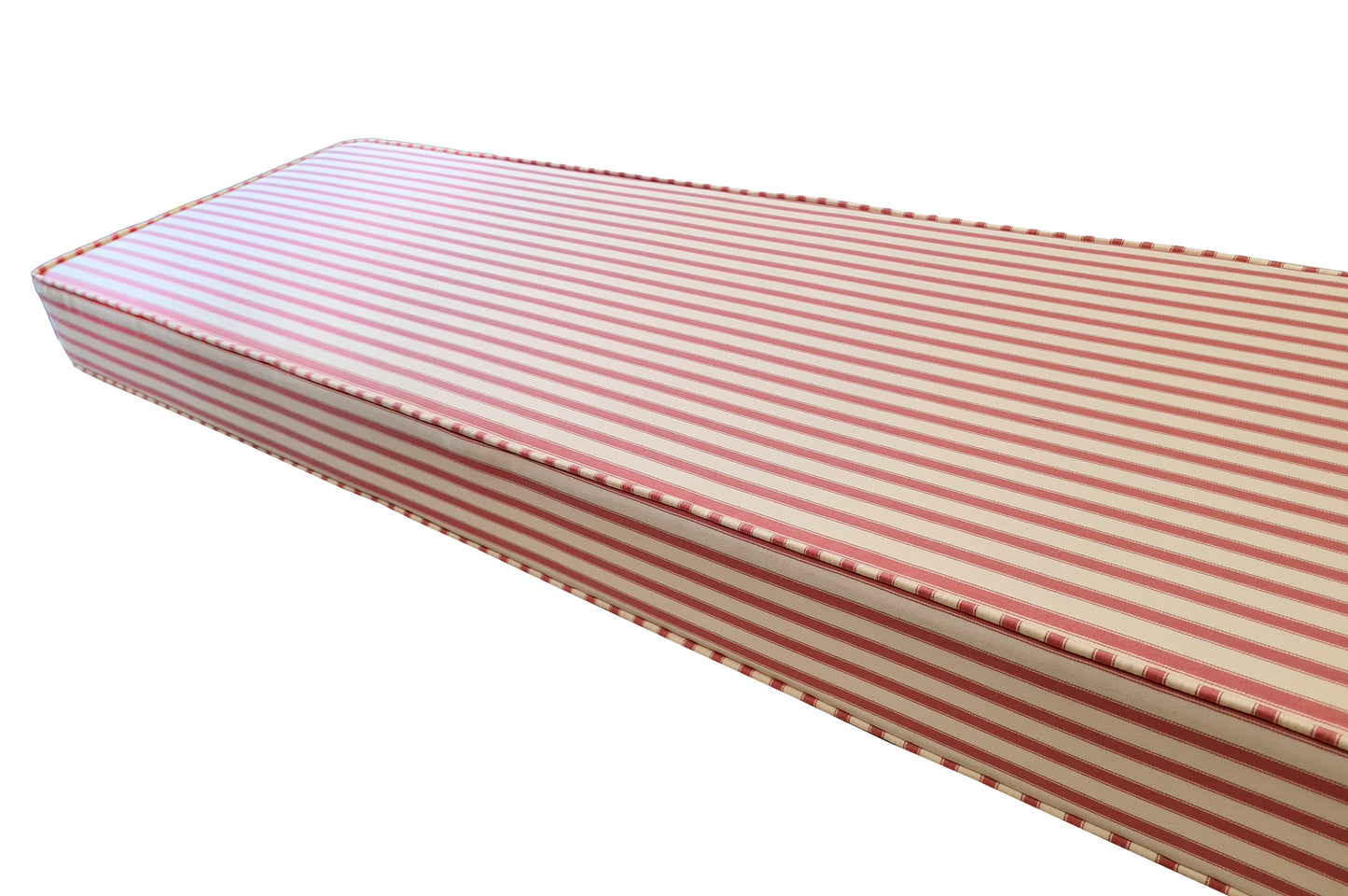 A made to measure bench cushion in 100% cotton striped fabric from Ian Mankin, a UK based fabric company with england based mills. High quality custom made bench cushion in natural fabric in a pink and cream candy stripe fabric. Piped edges and a long zip at the back. Country kitchen style extra seating cushion with firm foam inside and beading at the edges for strength. Thick upholstery thread, hand made with care in Yorkshire, UK. Firm foam, supportive banquette seating cushion, box edge, zip
