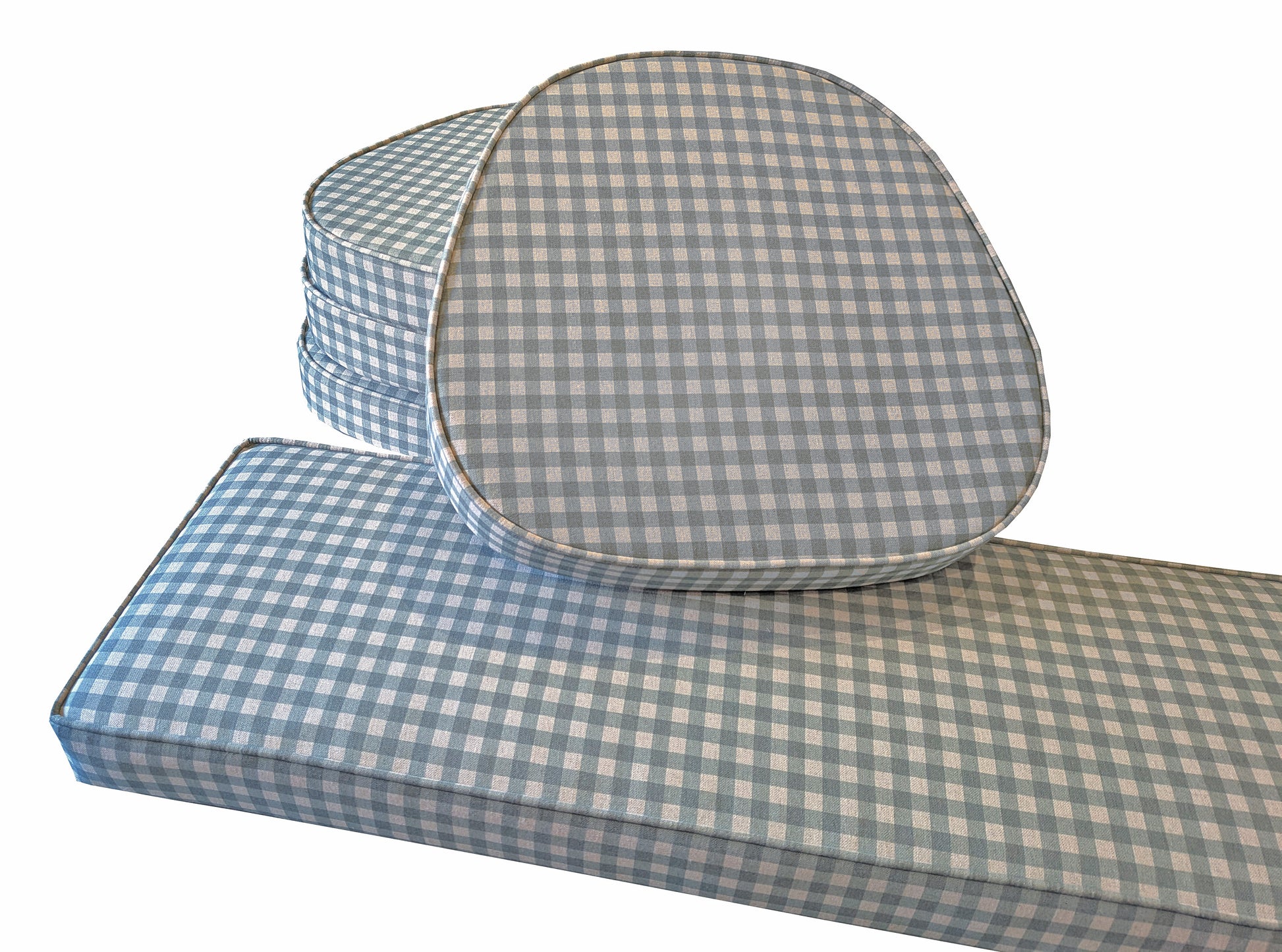 A set of four custom made chair cushions with curved front and back to fit between wooden back struts. Ercol swanback chair cushions made to measure. Green and cream gingham cotton and linen fabric seat pad cushions with fabric ties at the back. A matching long indoor bench cushion in the same traditional patterned check green and beige design. Firm supportive foam inside for long lasting seat cushions. Wheel back wooden country kitchen chairs. Pilot chair cushion. Zips at the back, stain proof