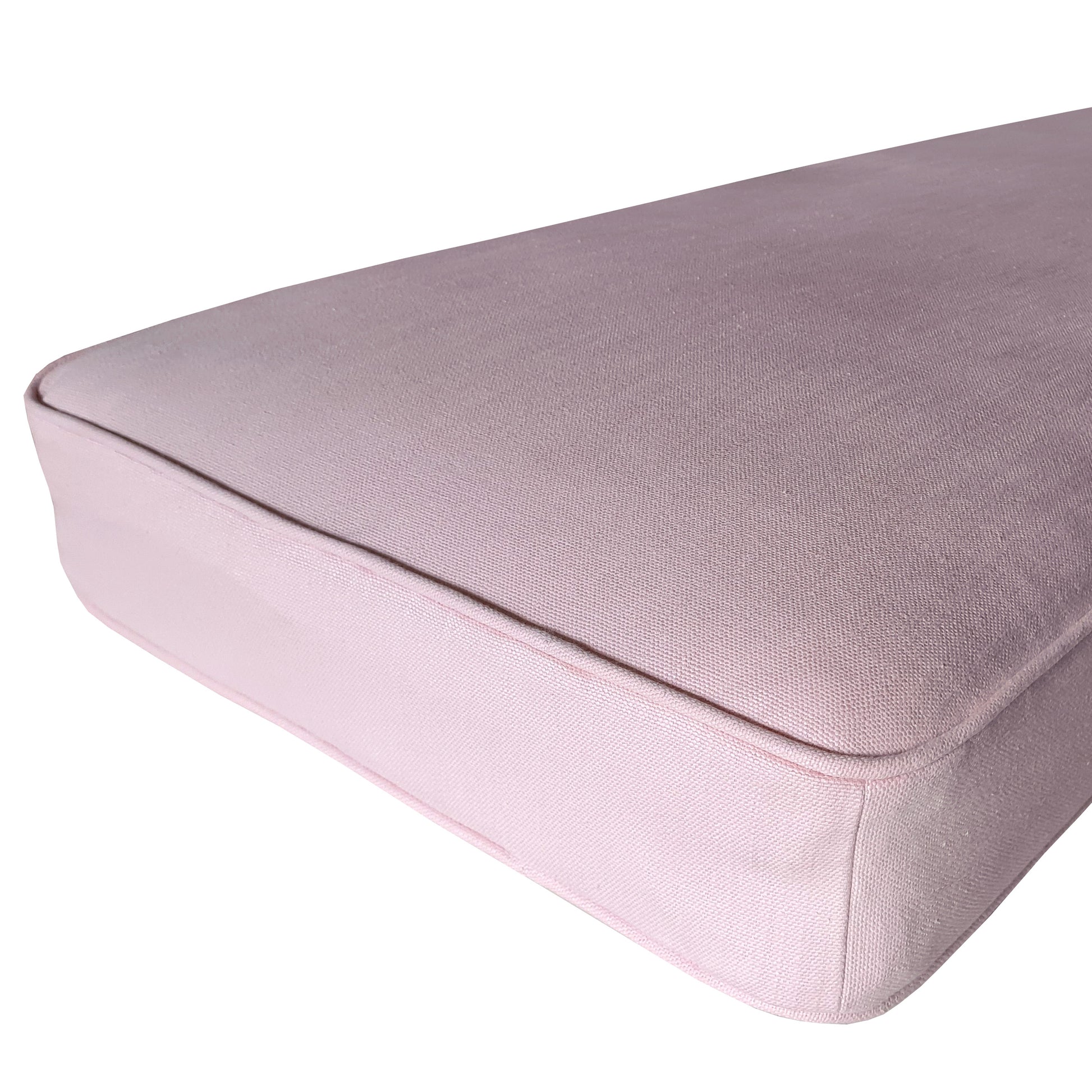 A natural fibre bench cushion with no fire retardant chemicals. Completely natural bench seating cushions made to measure. Cotton bench cushion covers made to order with latex rubber foam inside with a natural graphite fire safety treatment. Light pink custom made seat cushion for an in built wooden storage seating area to add extra seating to a kitchen dining room set. Perfect for dining spaces, banquette seating, window cushions, plump, soft and comfortable and long lasting. Zip and anti slip