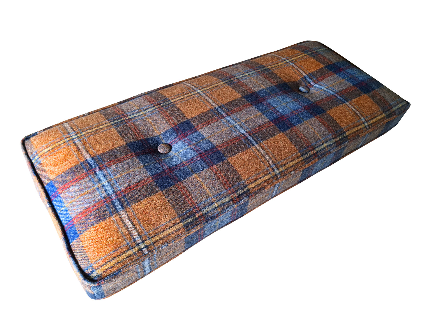 A small bench cushion. It has a handmade cover made with a 100% wool tartan fabric in a burnt orange, blue and red check pattern. The seating cushion has firm, quality foam inside with a dacron wrap to plump out the cushion and make it look very comfortable. The bench cushion has piping at the edges and has been hand tufted with buttons in the same wool upholstery fabric. The cushion is neat and well made. The bench cushion has been made to measure using customer's measurements.